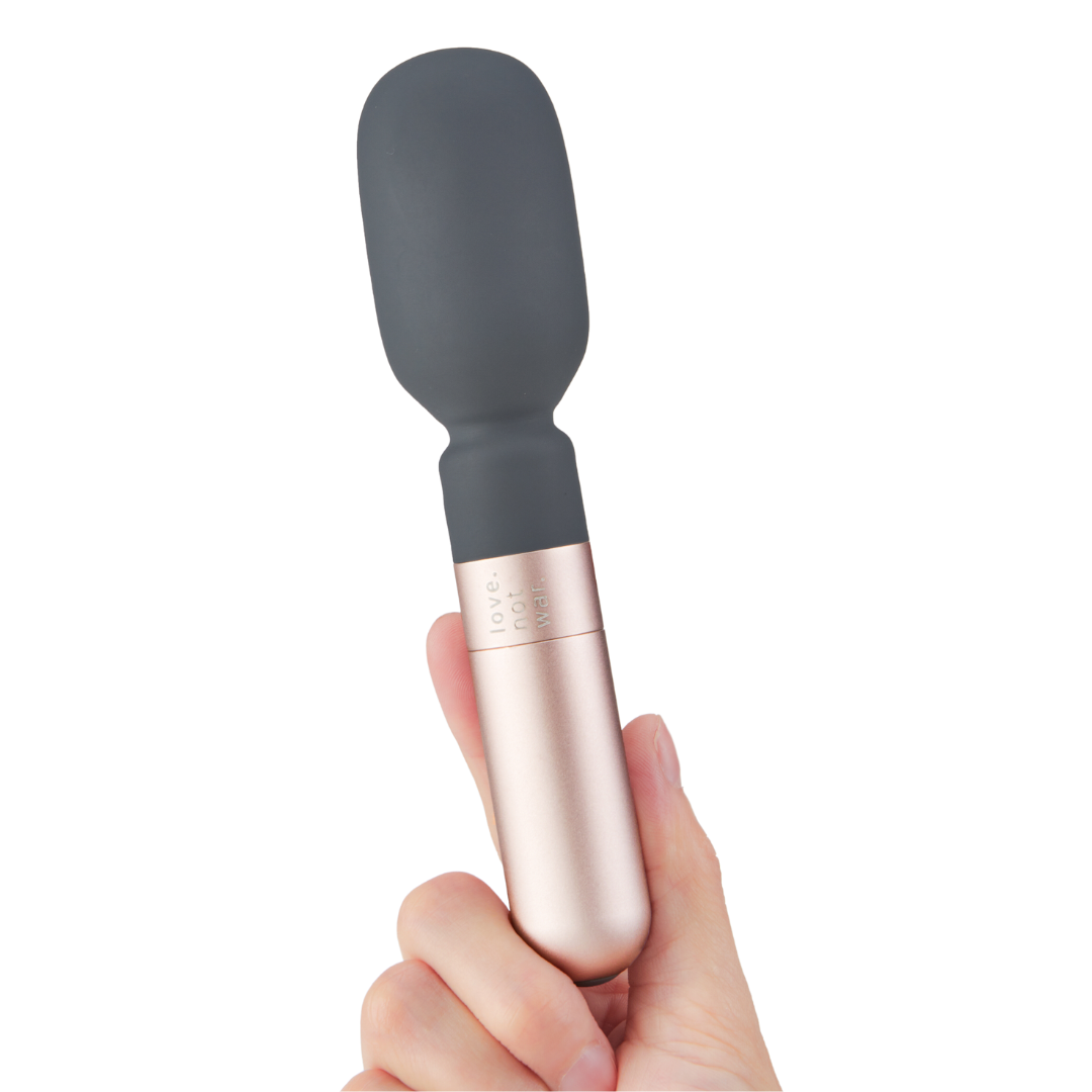 Hand holding Koi wand vibrator