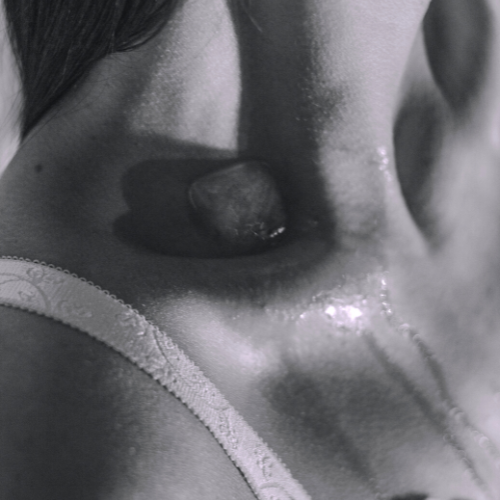 Ice cube melting on a women's shoulder