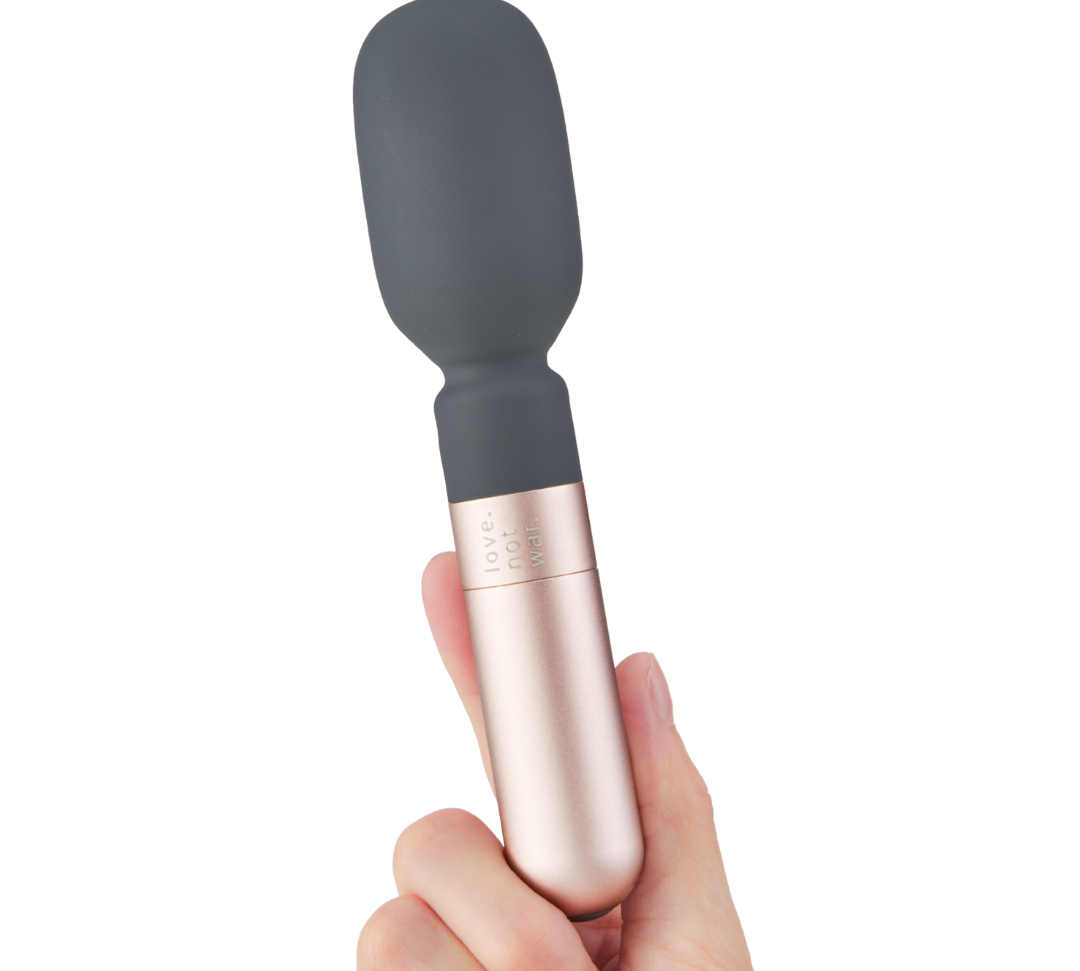 Hand holding Koi wand vibrator 
