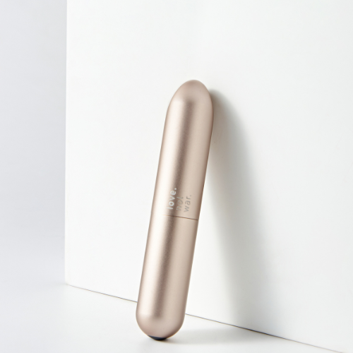 Maya bullet vibrator by Love Not War standing against a wall