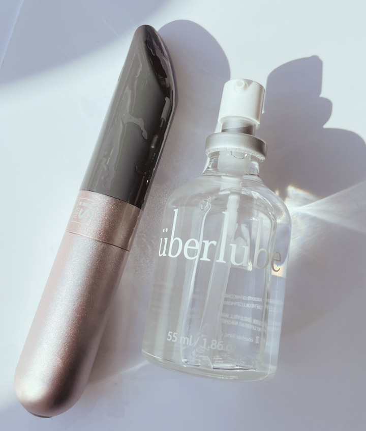 Uberlube bottle with Amore bullet vibrator covered in lube